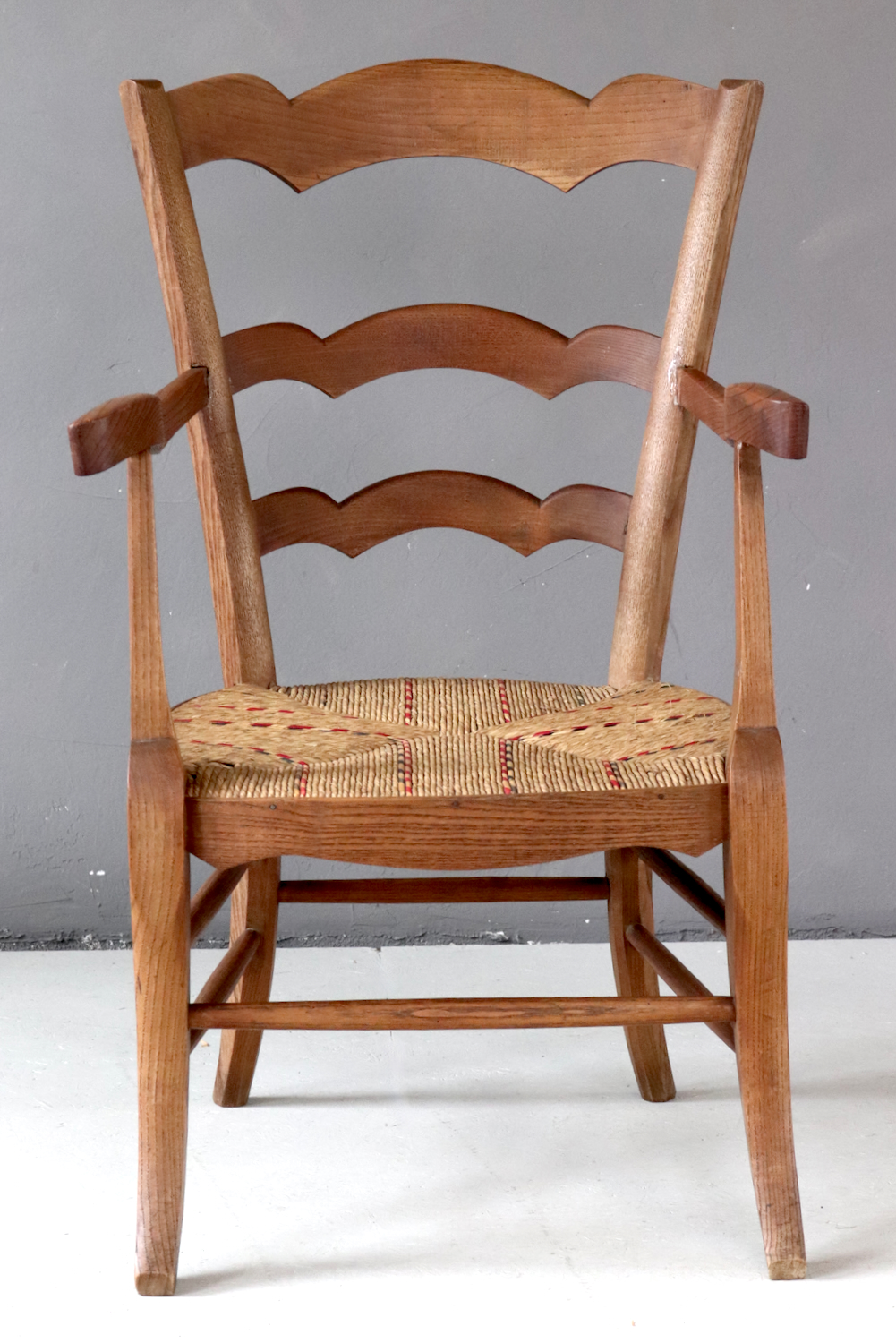 Antique wooden armchair with wickerwork