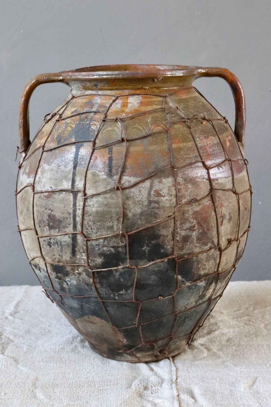 Antique terracotta pot with wire mesh