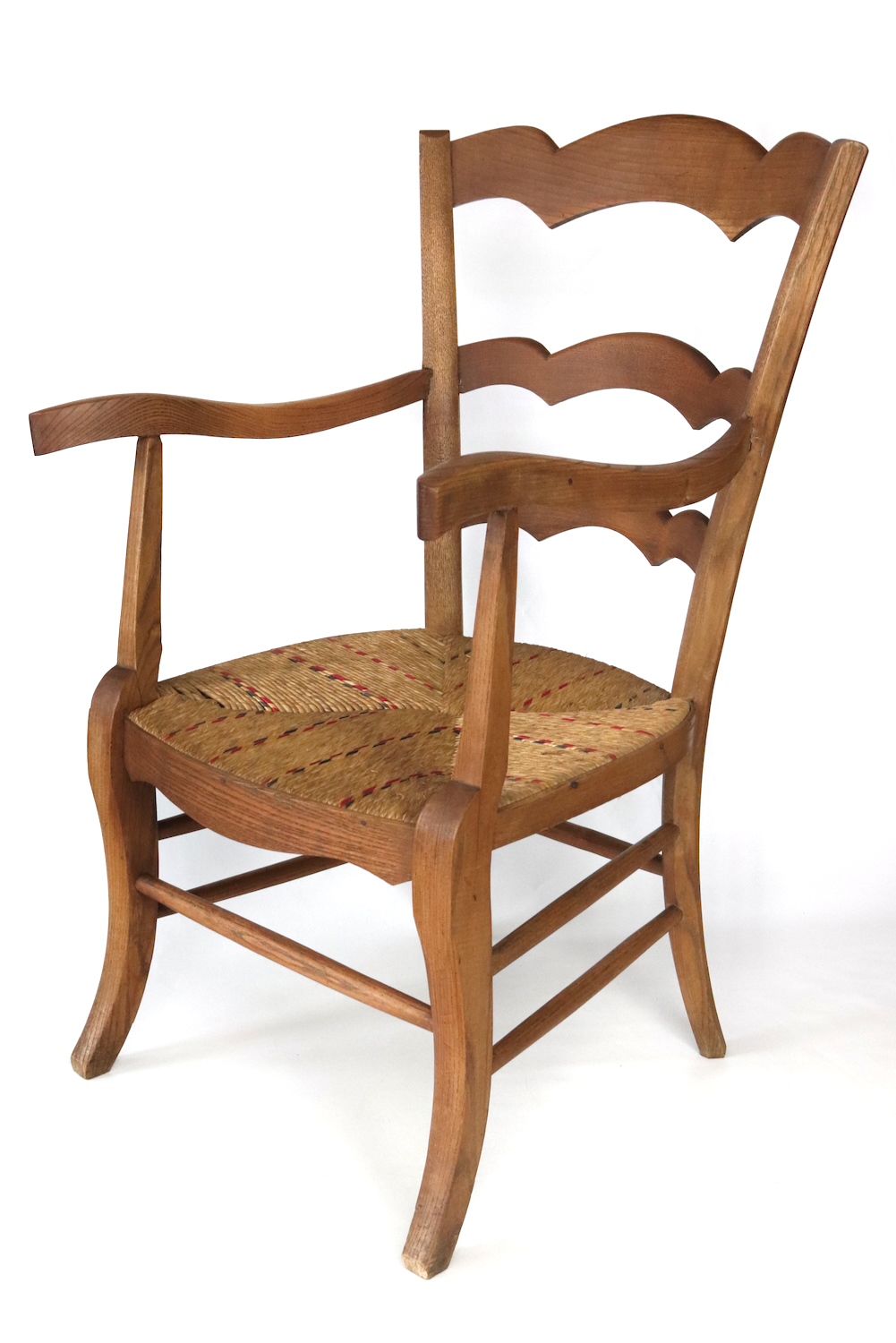 Antique wooden armchair with wickerwork