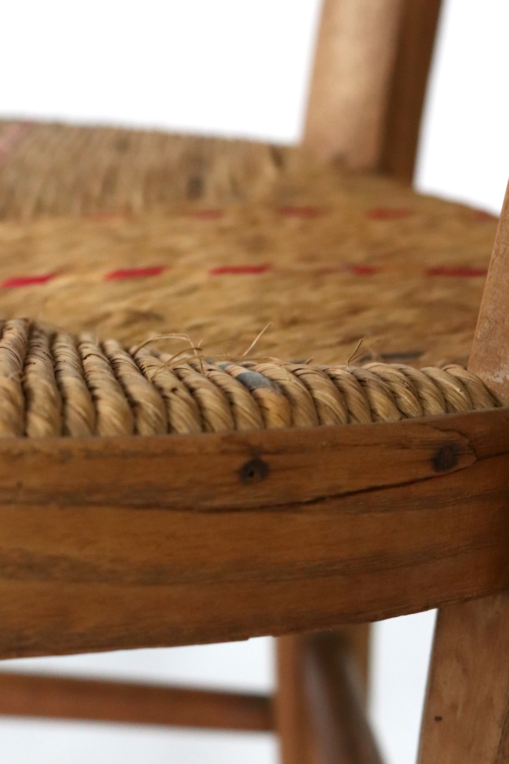 Antique wooden armchair with wickerwork